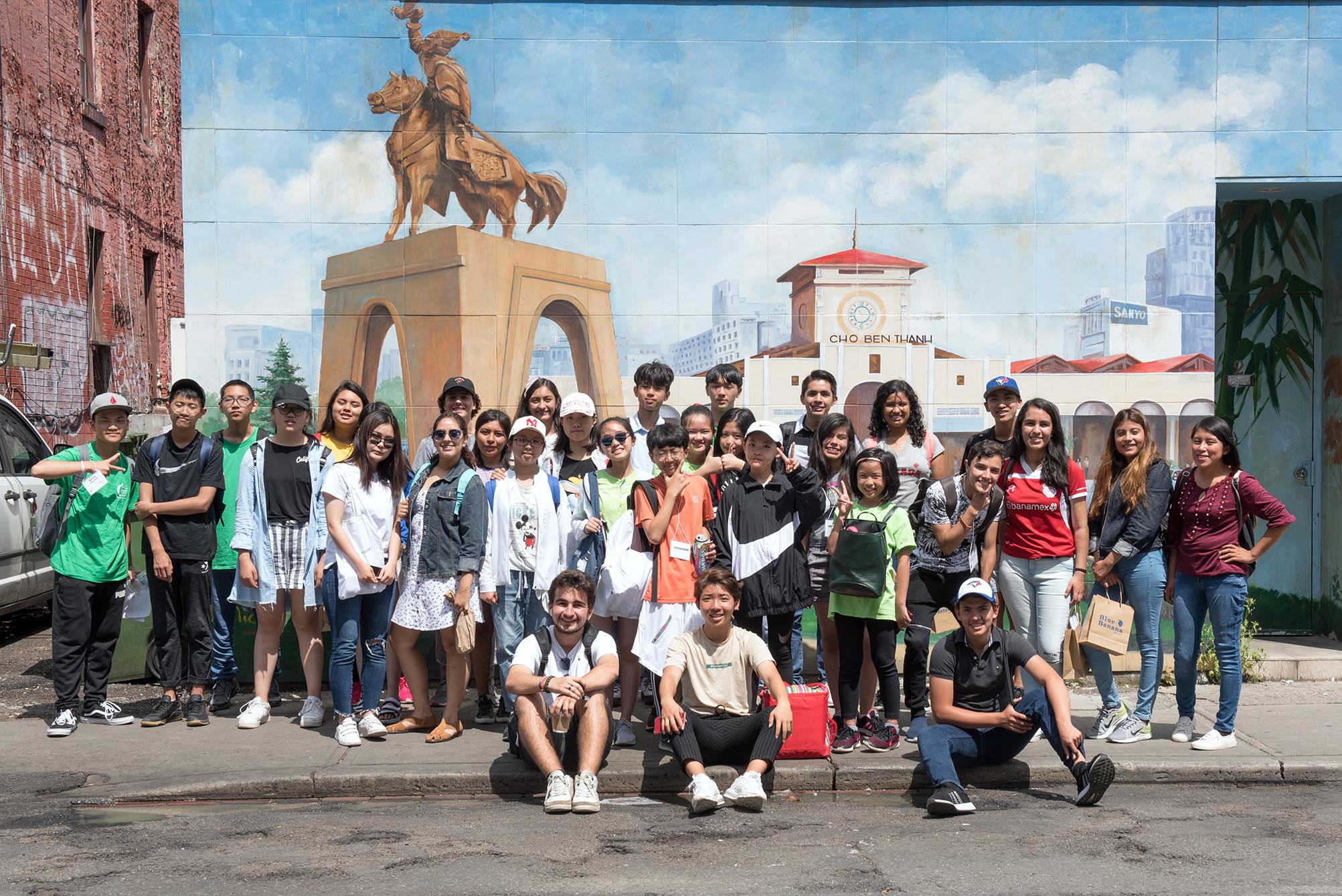 Group of students standing in front of statue  Open Gallery